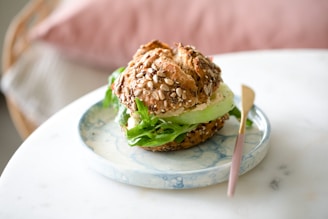 burger with lettuce and cheese on white ceramic plate