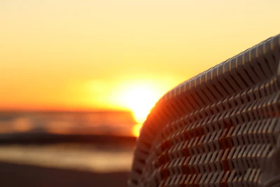 A close-up of a traditional kente cloth pattern glowing in the sunlight.