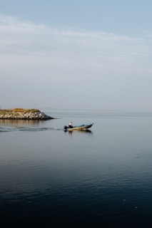 man in blue kayak on sea during daytime