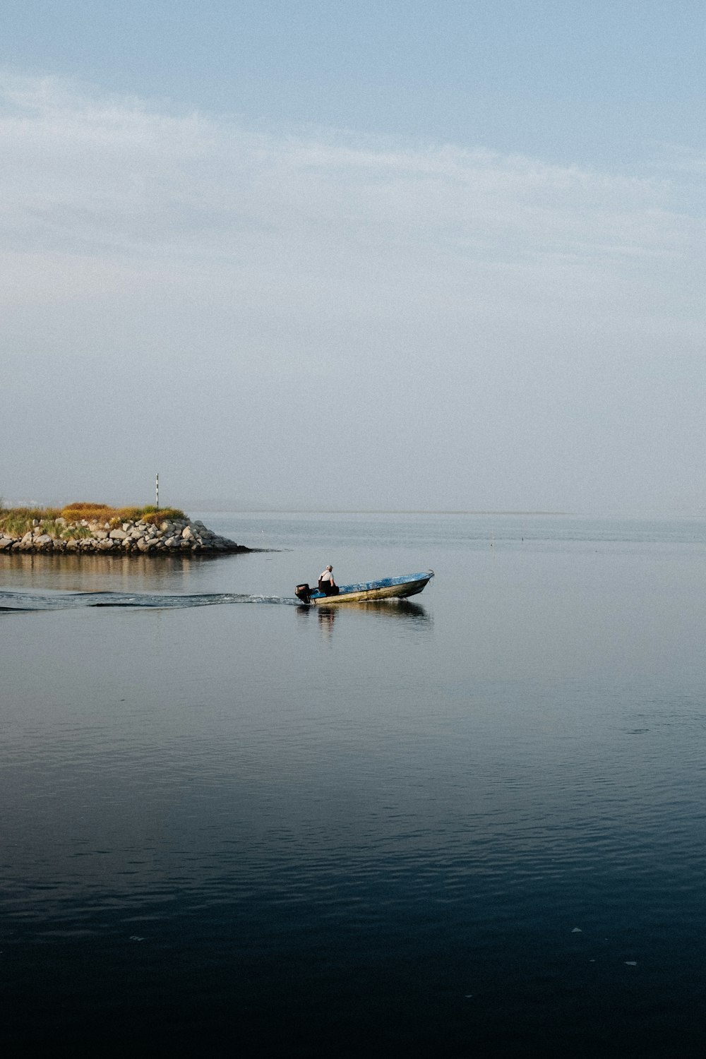 man in blue kayak on sea during daytime