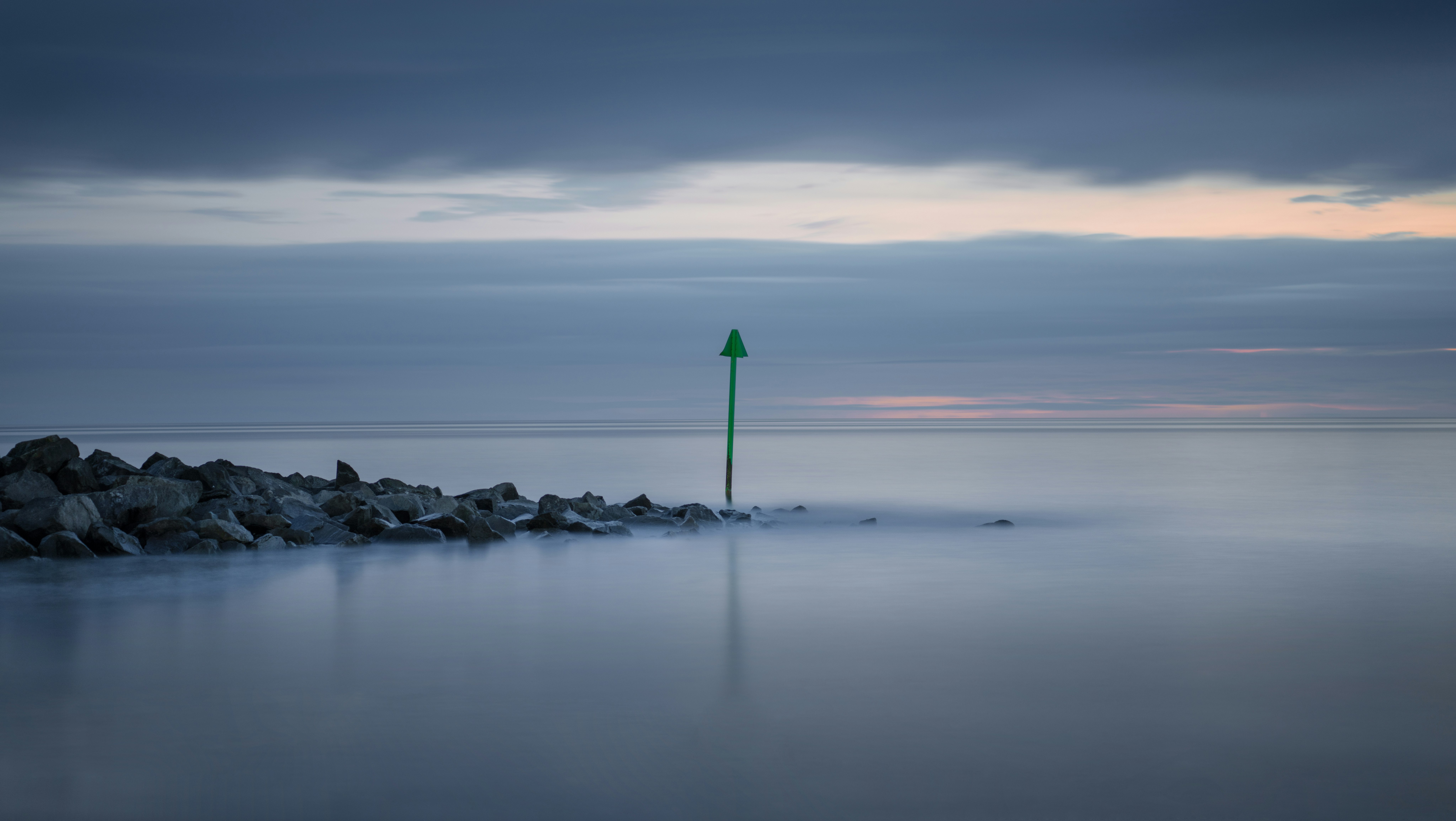 body of water under cloudy sky during daytime