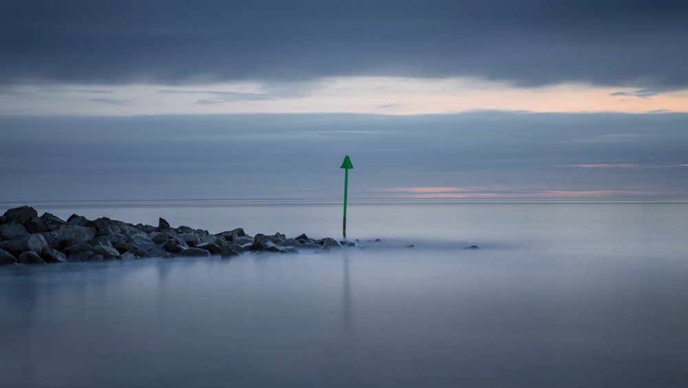 body of water under cloudy sky during daytime