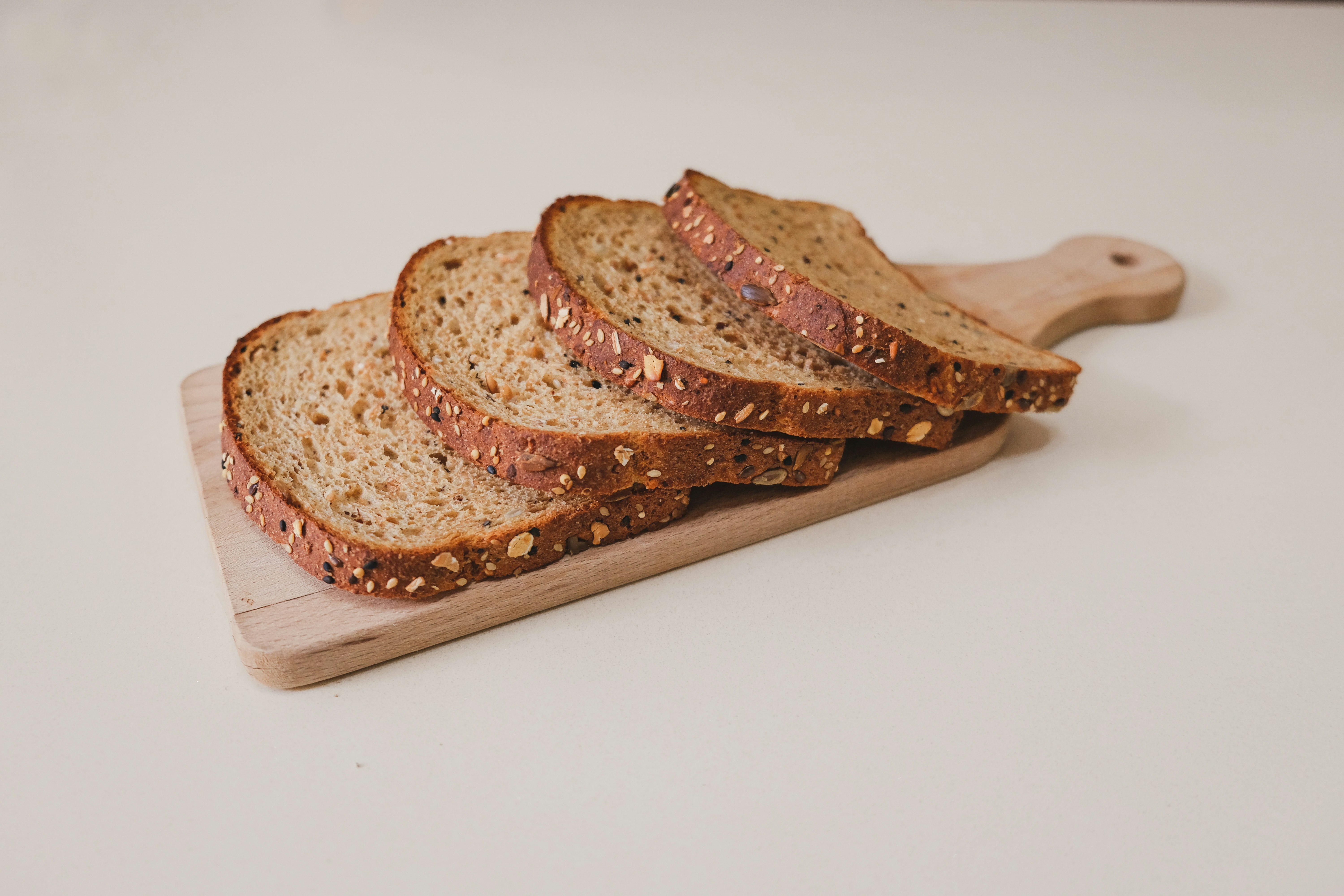 sliced bread on brown wooden chopping board