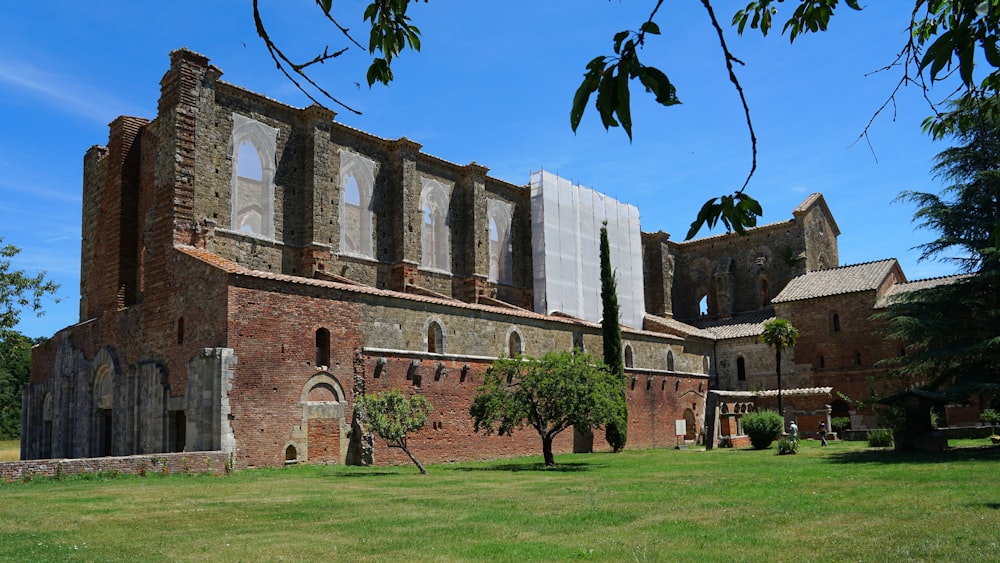 brown concrete building near green grass field during daytime