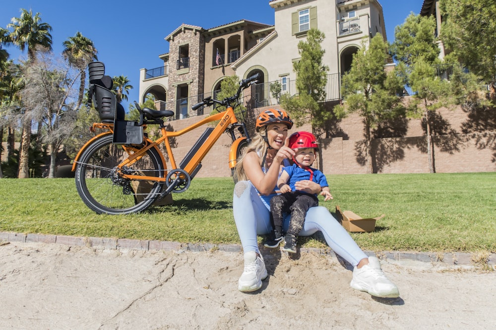 girl in red helmet riding on bicycle