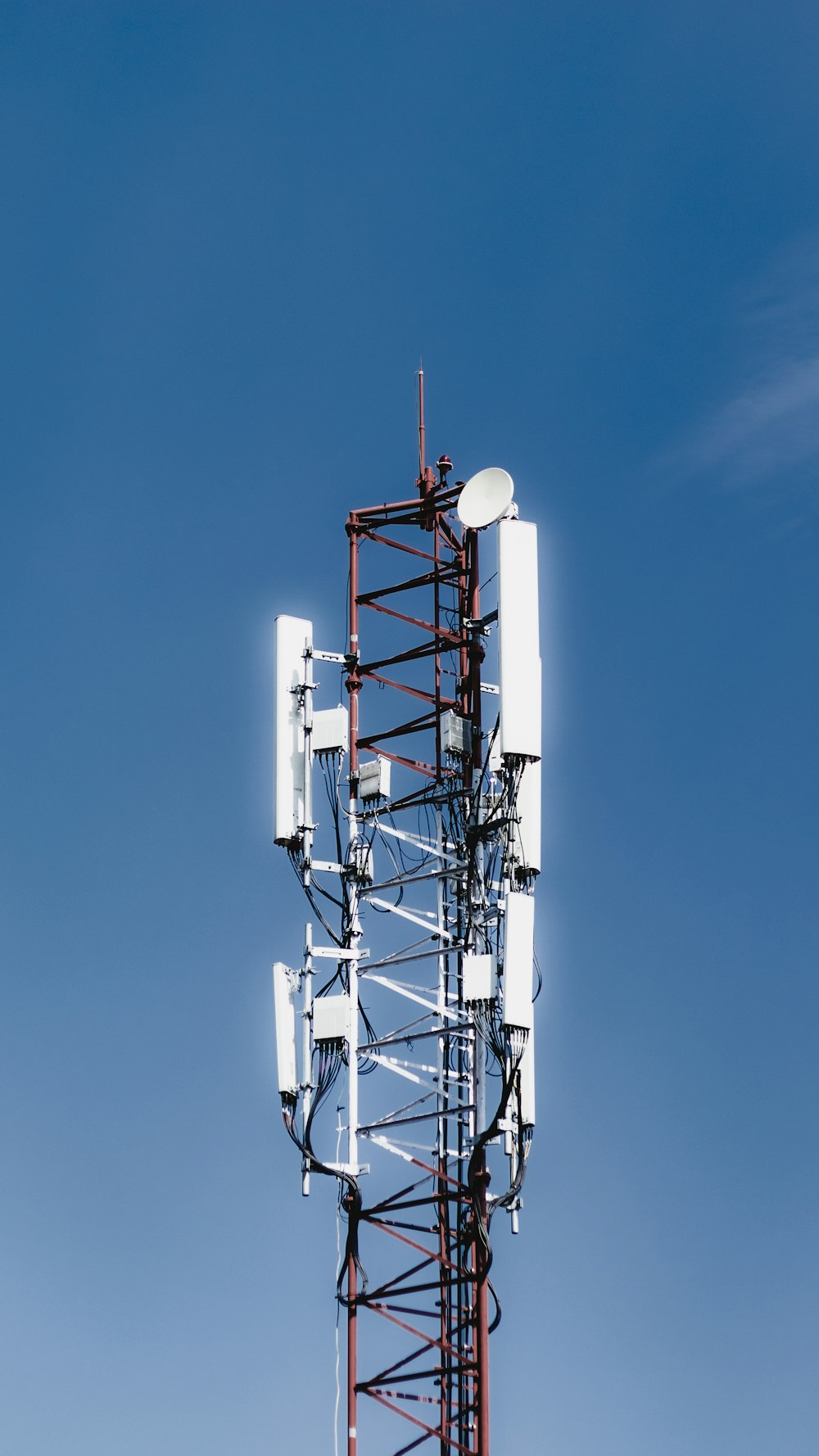 white and red metal tower under blue sky during daytime