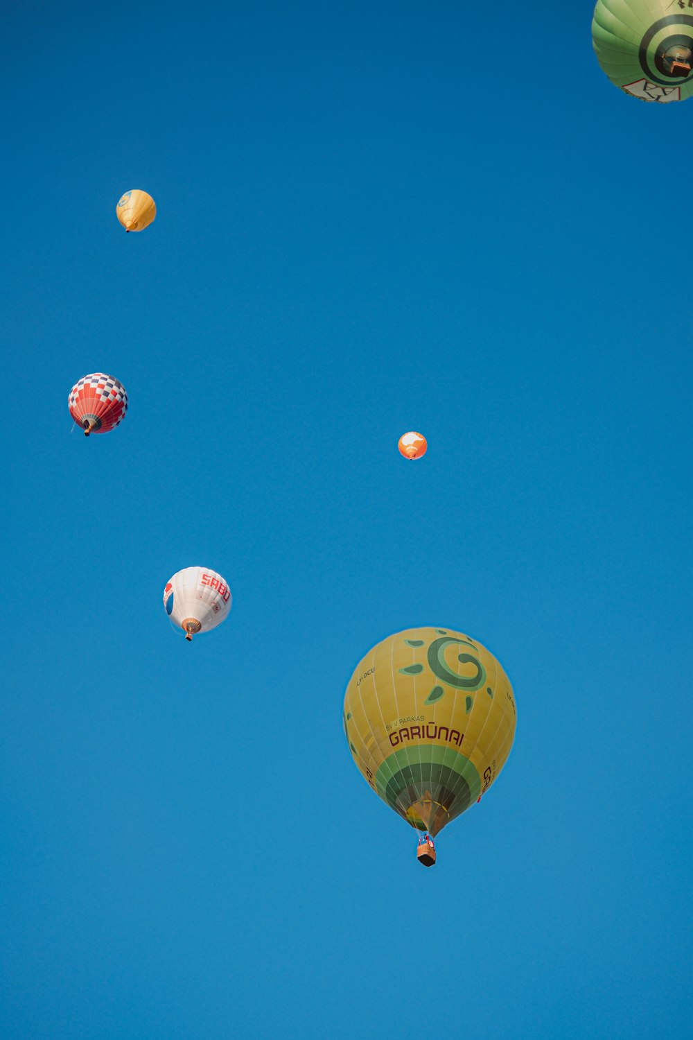 green hot air balloons on sky