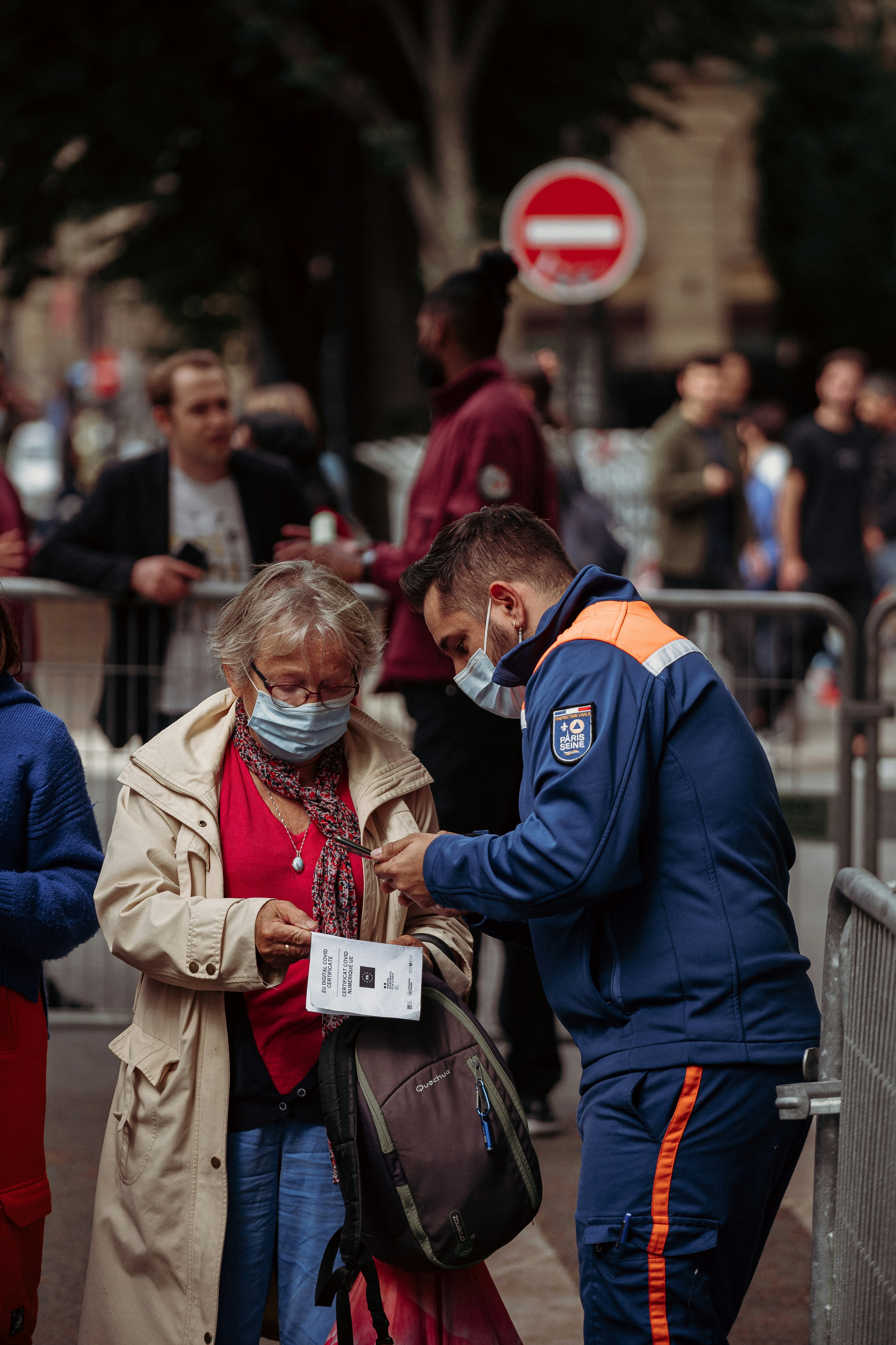 man in blue jacket standing beside woman in brown coat