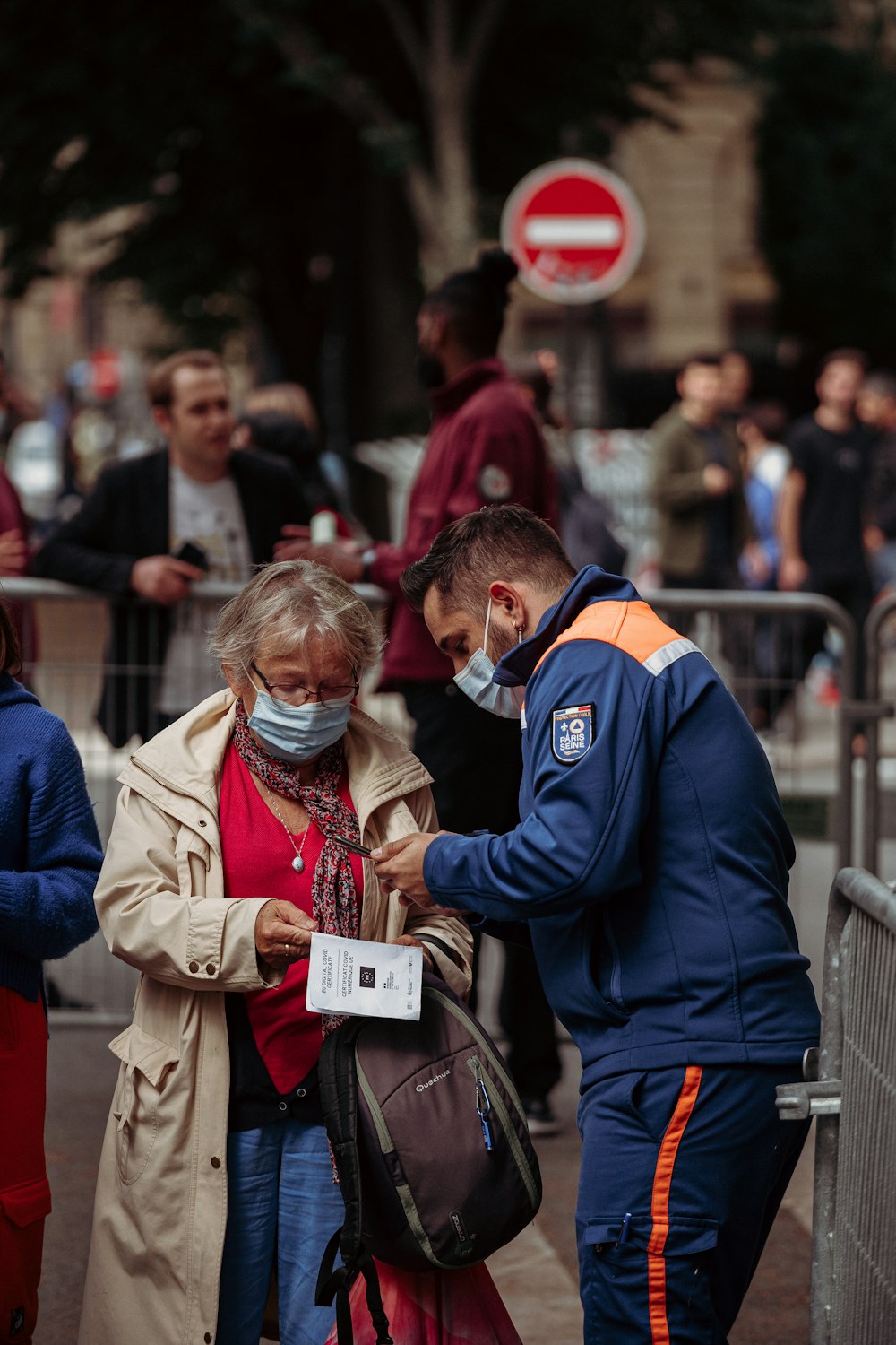 man in blue jacket standing beside woman in brown coat