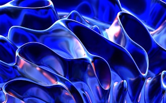 Abstract forms with fluid, wavy patterns in a metallic and glossy finish. Deep blues dominate with hints of reflective iridescent highlights.