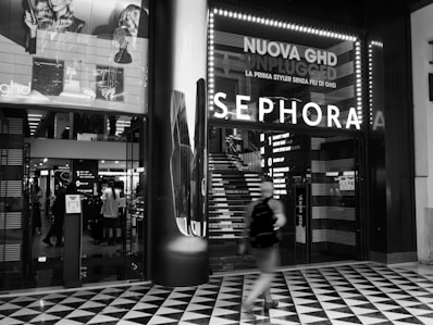 grayscale photo of people walking on sidewalk