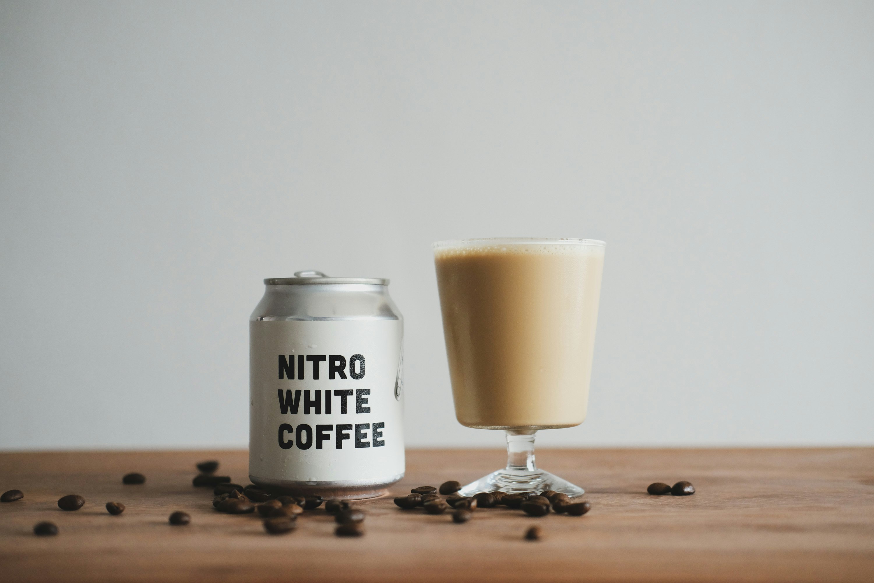 white and black ceramic mug on brown wooden table