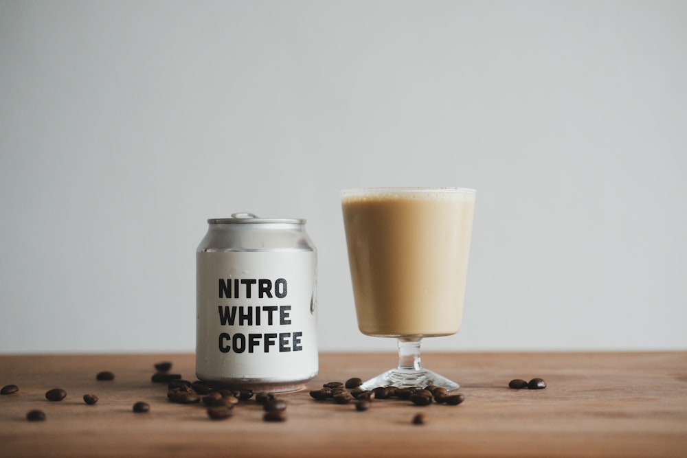 white and black ceramic mug on brown wooden table