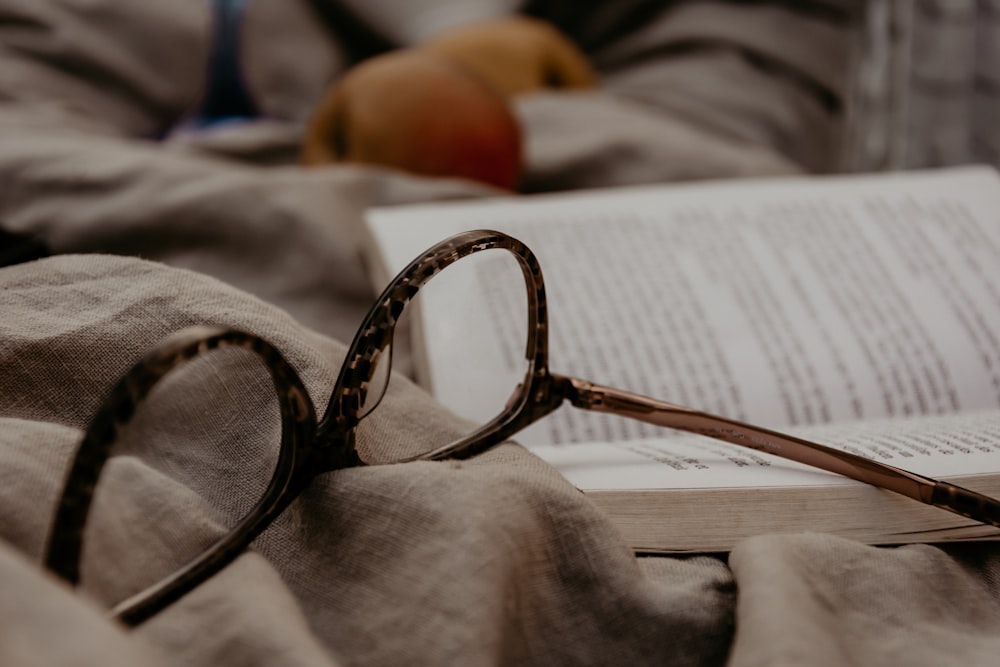 black framed eyeglasses on white textile