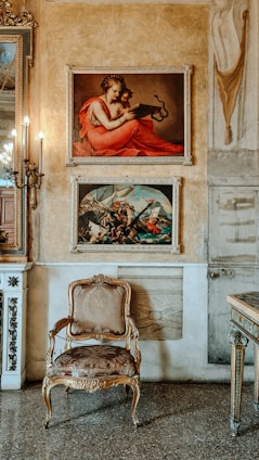Elegant living room with warm lighting showcasing historic Milan paintings and a view of the Navigli canals at sunset.