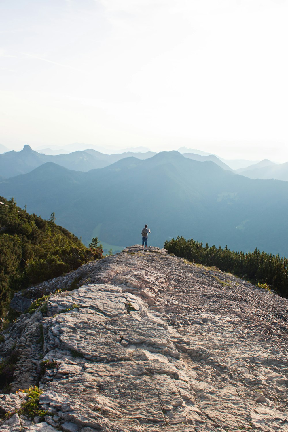 person standing on rock mountain during daytime