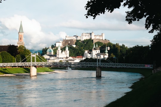 bridge over river during daytime in Hohensalzburg Castle Austria