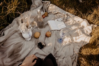 A cozy scene of young people enjoying a casual outdoor picnic with minimalistic lifestyle items.