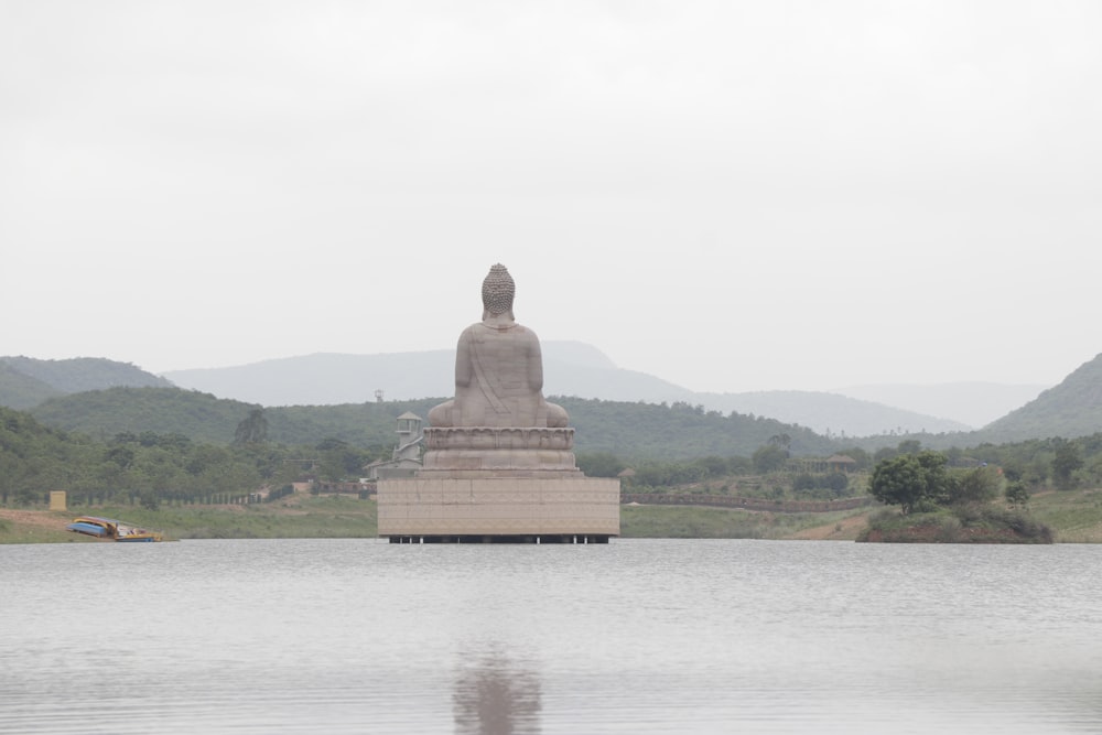 brown concrete statue near body of water during daytime