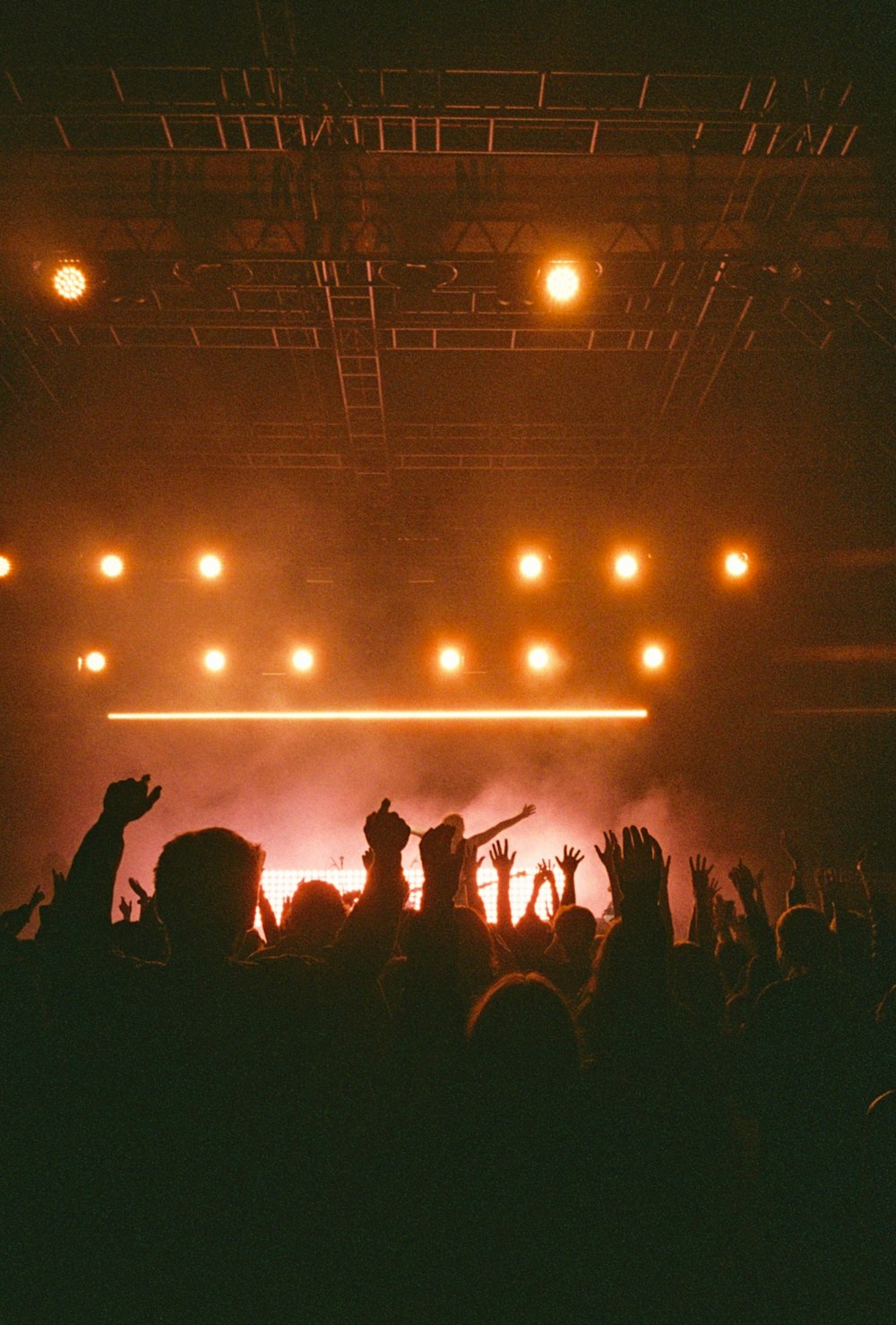 people standing on stage with lights