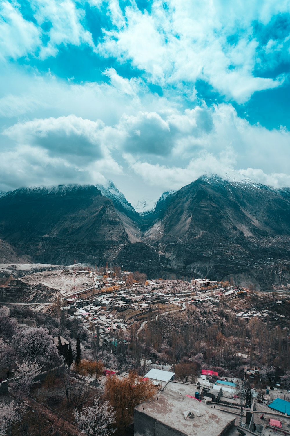 brown and gray mountains under white clouds and blue sky during daytime