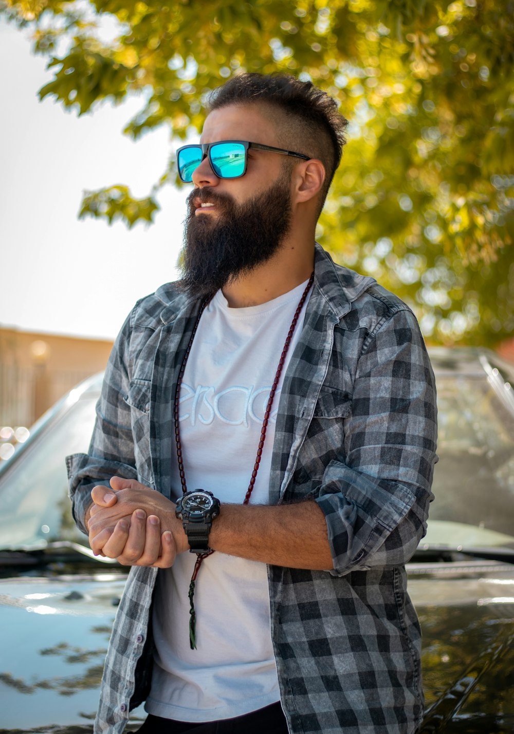man in black and white plaid button up shirt wearing black sunglasses
