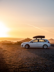 white chevrolet camaro on road during sunset