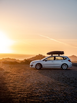 white chevrolet camaro on road during sunset