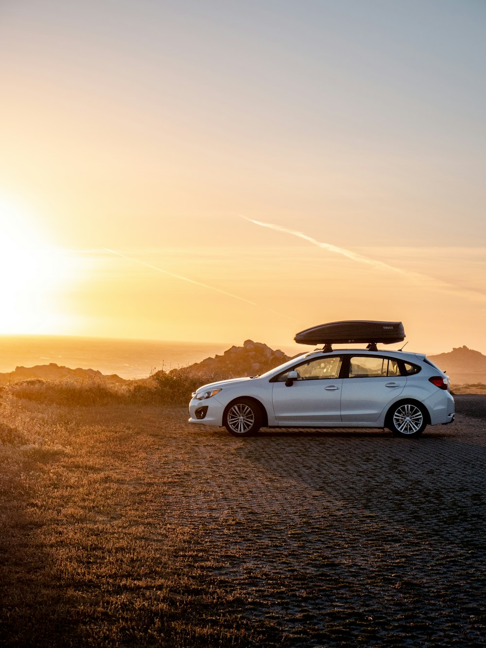 white chevrolet camaro on road during sunset