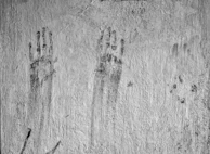 Artist hands carefully inspecting a UV-cured print on a textured material, highlighting craftsmanship.