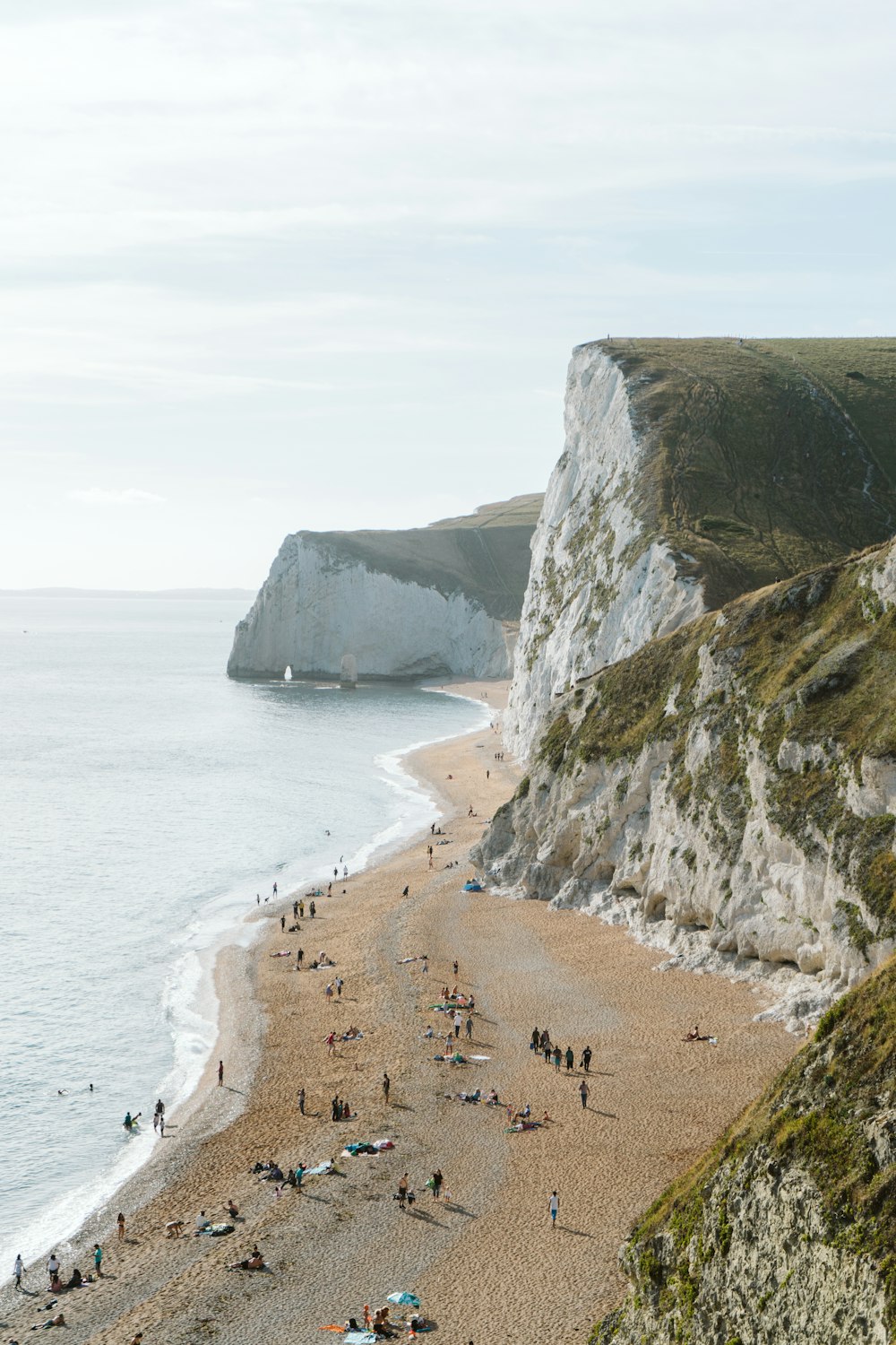 brown sand beach near gray rock formation during daytime