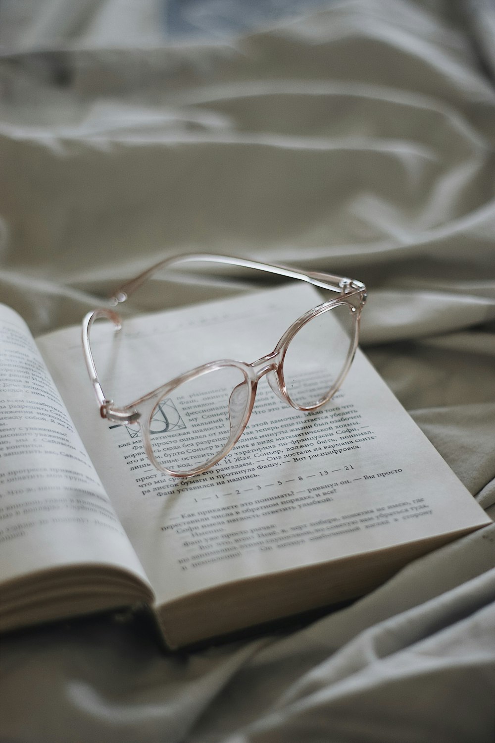 silver framed eyeglasses on book page