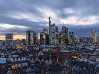 city skyline under white clouds during daytime