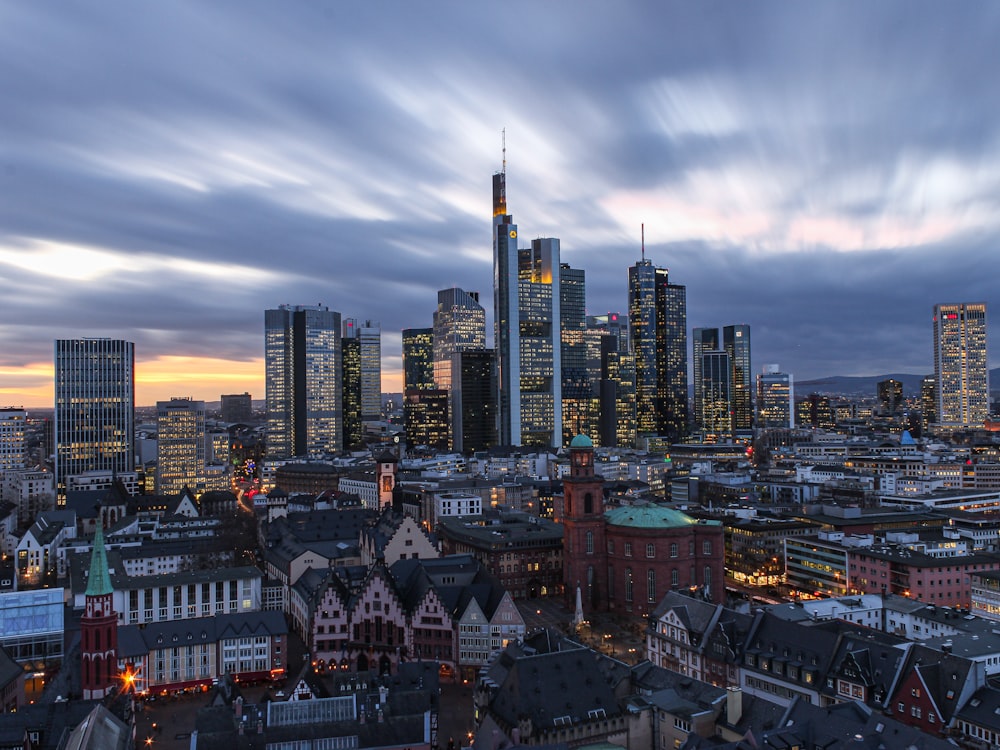 city skyline under white clouds during daytime