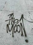 too the moon written on street pavement
