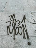 too the moon written on street pavement
