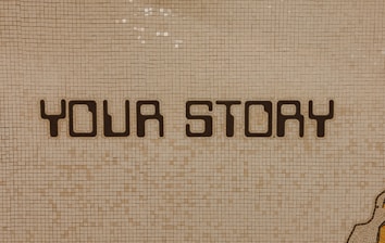 a tiled wall with the words yots aloy on it