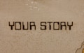 The image contains a mosaic wall with the words 'YOUR STORY' written in bold, dark letters. The tiles are small and mostly uniform, giving a textured appearance to the background.
