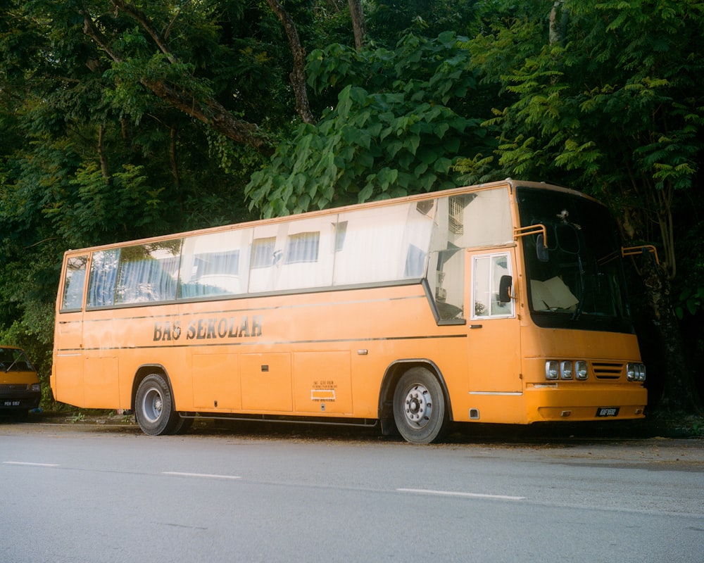 yellow and white bus on road during daytime
