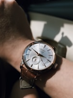 Close-up of a watch with a leather strap and shiny metal details