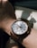 Hands of a person admiring a custom watch on their wrist in natural light.