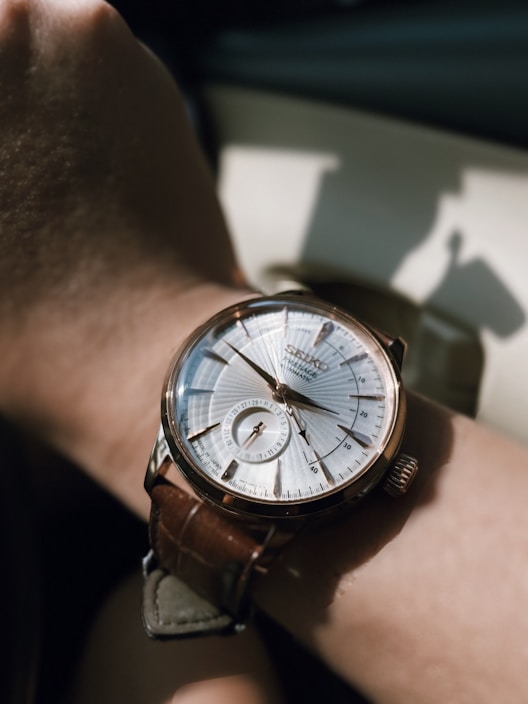 Stylish men's watch displayed on a wrist outdoors in natural light