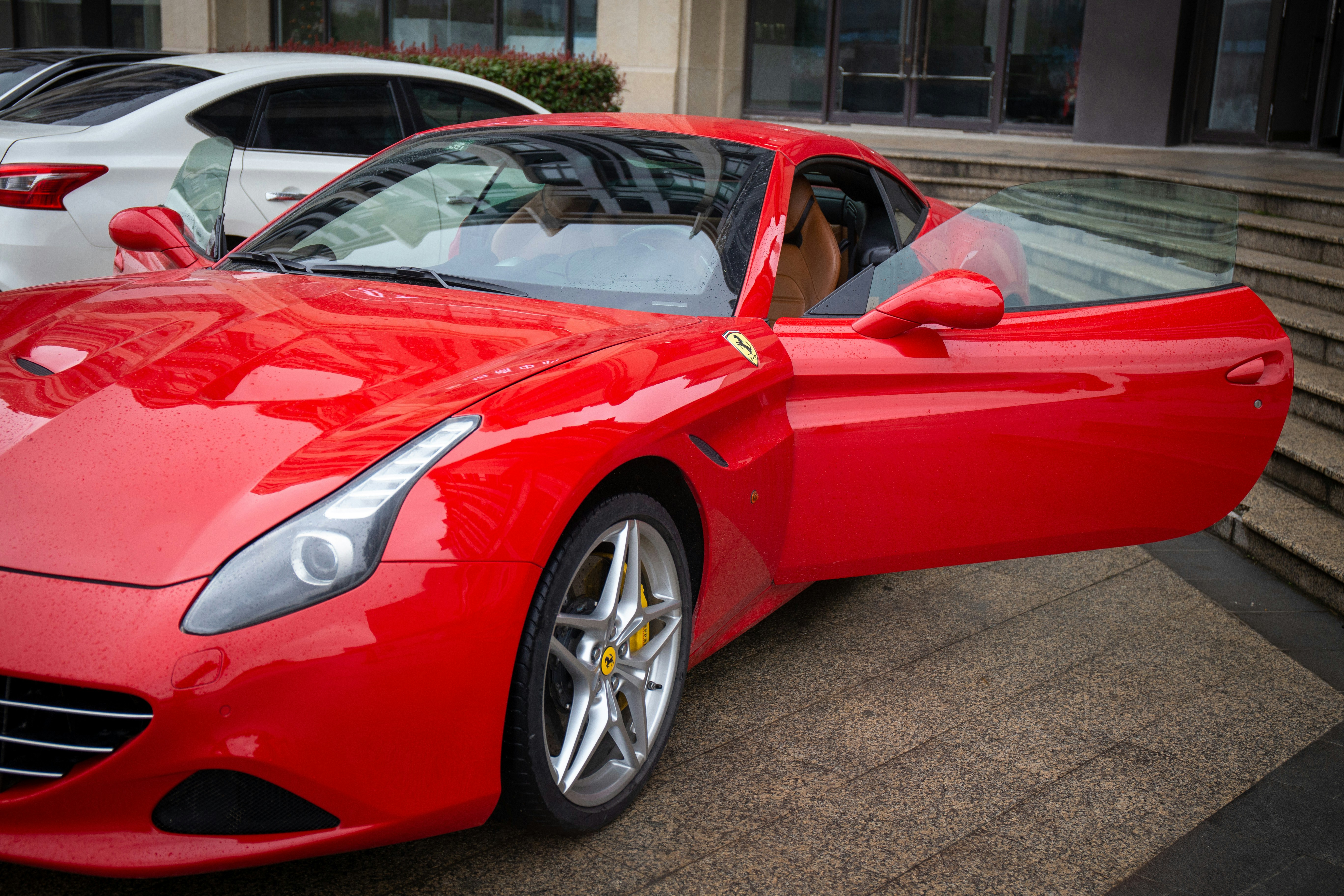 red ferrari 458 italia parked on gray pavement