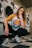woman in white crew neck t-shirt and black pants sitting on black and white stairs