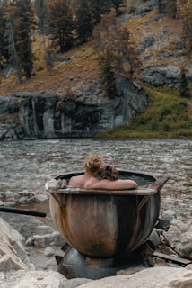 woman in brown boat on river during daytime