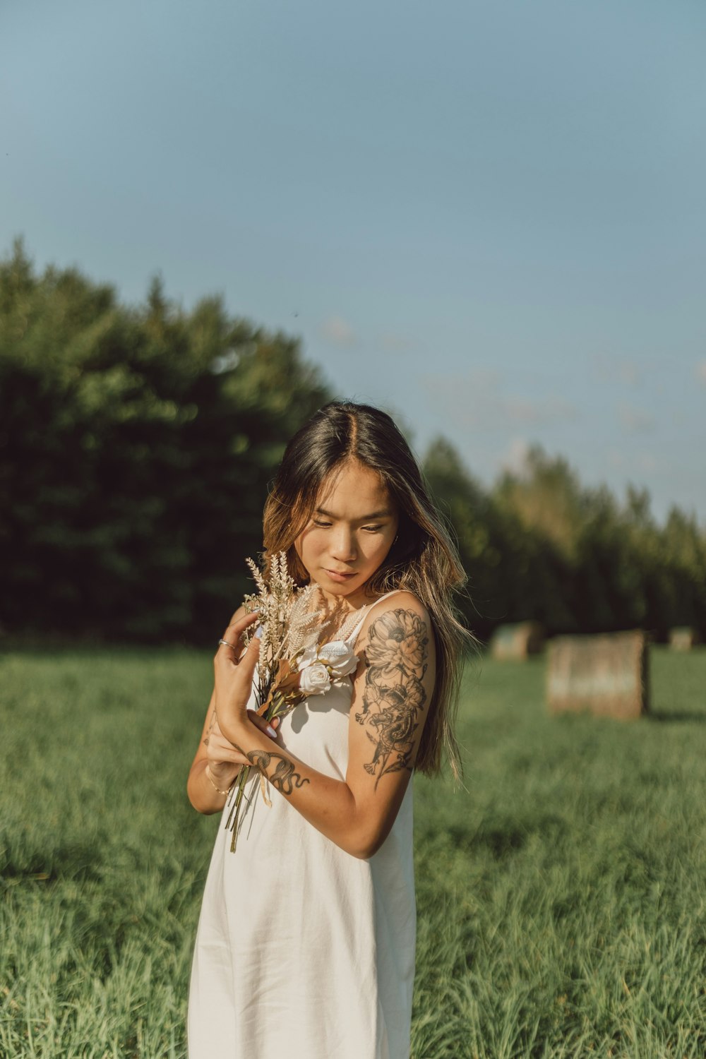 woman in white dress carrying baby in white dress