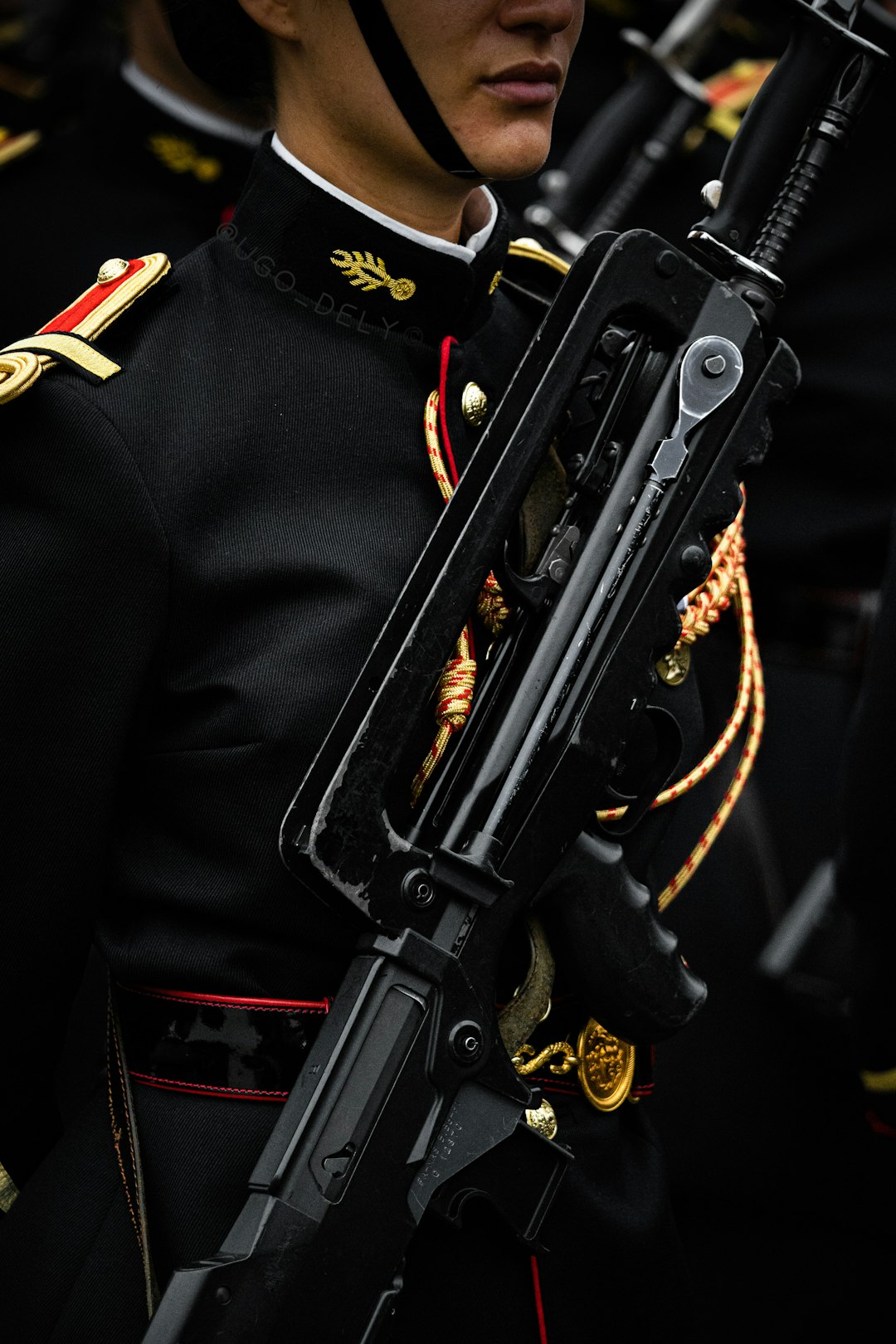black rifle on black and gold coat