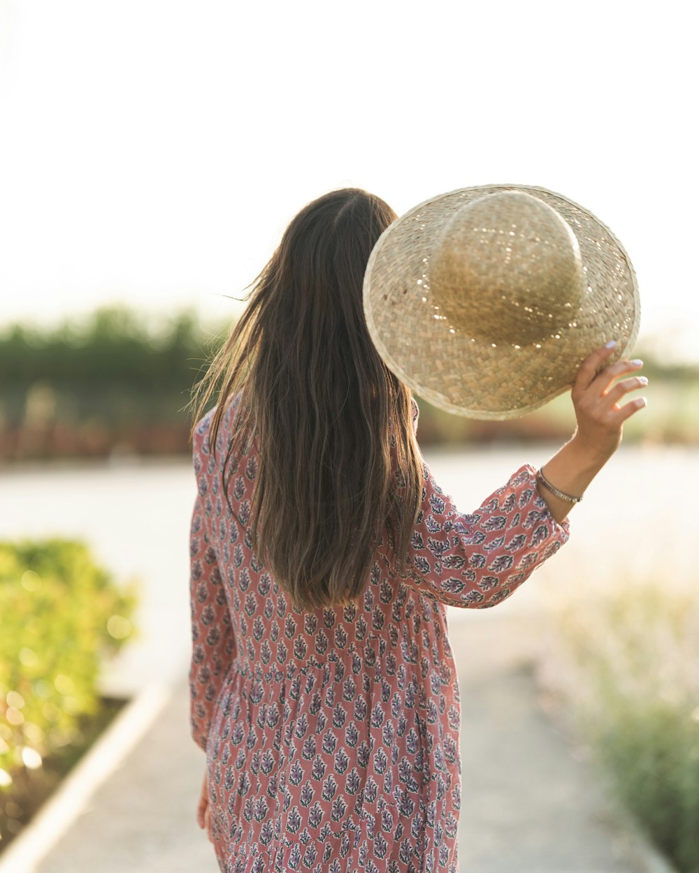 woman in red and blue long sleeve shirt holding white ball during daytime