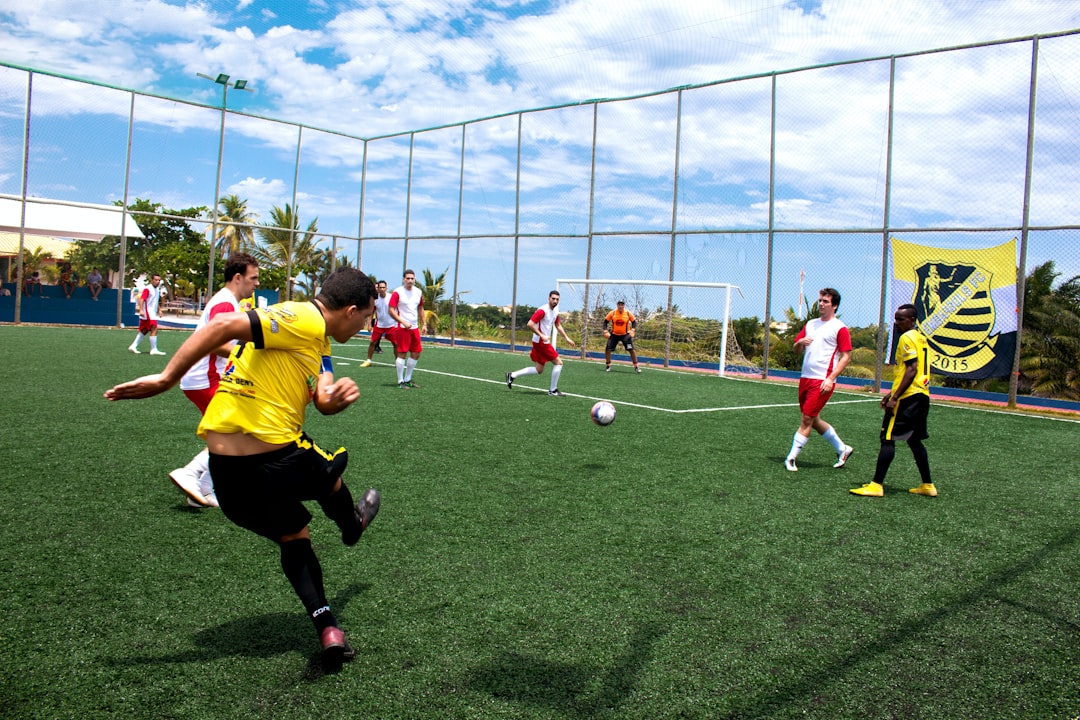 group of people playing soccer during daytime