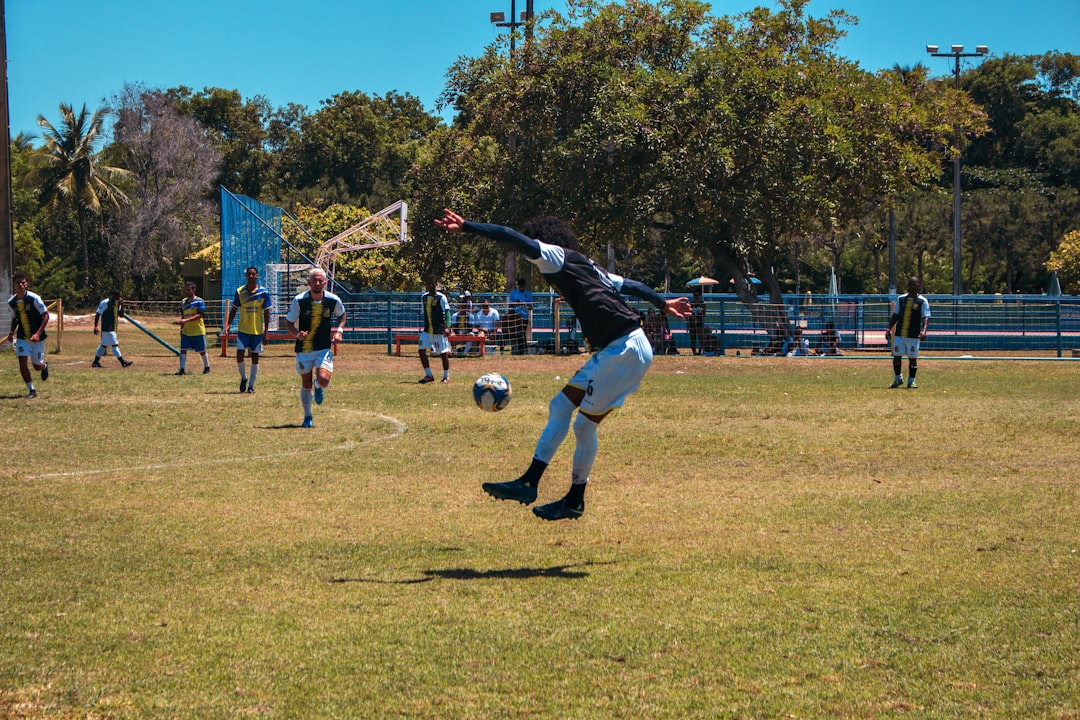 people playing soccer during daytime